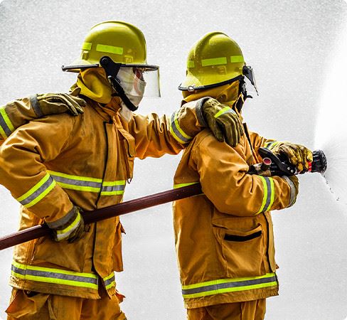 Two Fire Fighters Spraying Water