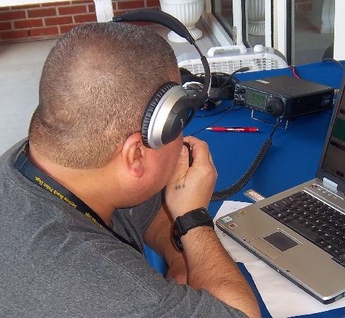 DB CERT Amateur Radio Team member working the radio 488 x 450